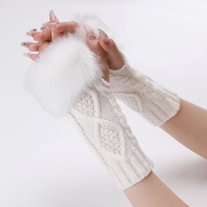 Close-up of white cable knit fingerless gloves with luxurious faux fur trim detail