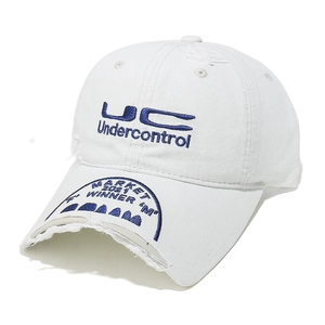 Detailed close-up of distressed white canvas baseball cap with blue letter embroidery