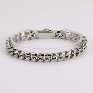 Classic silver stainless steel Cuban link bracelet with rectangle clasp on a plain stand