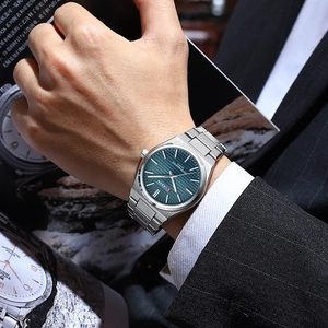 Macro detail of Curren quartz watch with blue textured dial and silver steel band