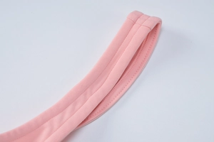 Detail shot of the pink dress showing high-quality double stitching on the fabric edge