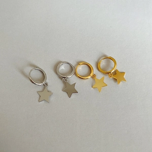 Detailed view of polished sterling silver and gold star pendant hoop earrings set