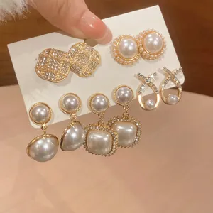 Elegant 5-piece gold stud earring set with white pearls and sparkling diamond accents