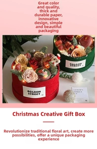 Detail of Christmas round gift box with roses, dried fruits, and cozy LED lighting