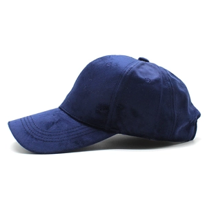 Detail shot of navy blue velvet baseball cap with curved brim and soft texture