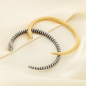 Snake wrap bracelets set in gold and silver finish with detailed scale texture on silk