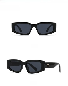 Front and 45-degree side views of black rectangle sunglasses with gold metal hinges