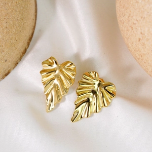 Minimalist 14K gold plated leaf earrings for women on elegant white satin fabric