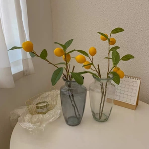 Detailed view of lifelike artificial lemon branch with vibrant fruit and green leaves