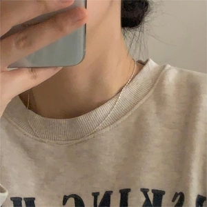 Minimalist 925 sterling silver water wave chain necklace shown on neck in a casual setting