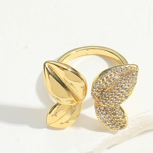 Detailed view of luxury gold bow ring with sparkling crystals on white marble