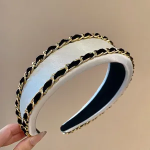 Padded white satin headband with gold chain weave detail for high-top hair styling