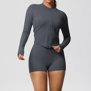 Detail of slim-fit charcoal grey yoga set featuring a zipper jacket and high-waist shorts