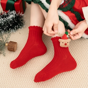 Kids red Christmas socks with cute 3D reindeer doll and festive holiday decorations