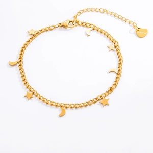 Macro shot of gold stainless steel bracelet featuring star and moon charms with S.Steel engraving