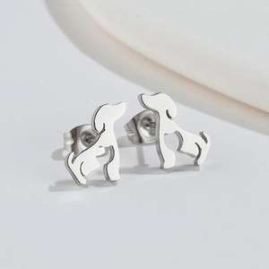 Close-up of cute silver puppy dog stud earrings in high-quality polished stainless steel