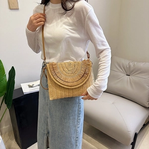 Bohemian raffia straw clutch bag with leather strap and tassel detail for women