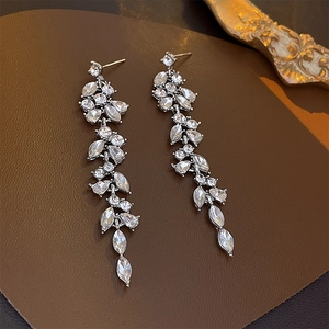 Detailed view of elegant silver tassel leaf earrings featuring sparkling crystal rhinestones