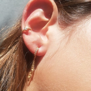 Macro view of gold-plated S925 star moon cross pendant earrings with zircon accents