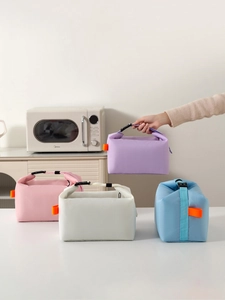 Detail of insulated lunch bags in four pastel colors with adjustable handles