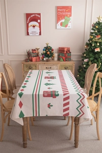 Christmas tablecloth with gift and tree prints on a festive dining table scene