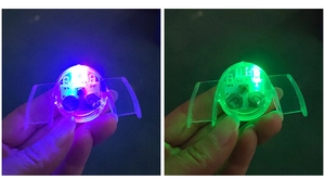 Detailed close-up of LED glowing mouth guard with bright blue and green light effects