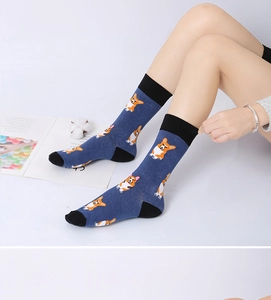 Detail of navy blue cotton socks featuring cute orange corgi dog print and black accents