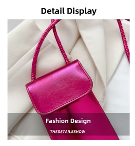 Close-up of hot pink mini phone bag with glossy metallic finish and sleek strap