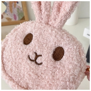 Close-up of pink plush bunny bag showing soft teddy fleece texture and embroidery