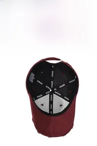 Internal detail of a burgundy baseball cap showing breathable holes and NY&JA sweatband