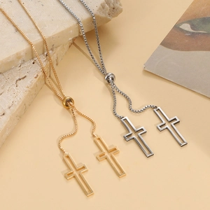 Detail of gold and silver adjustable cross necklaces with sliding beads on stone