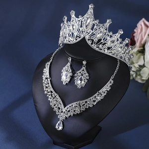 Detailed view of silver bridal jewelry set with sparkling rhinestones on a black bust