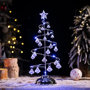 Modern spiral Christmas tree lamp with cool white LED lights on a snowy background