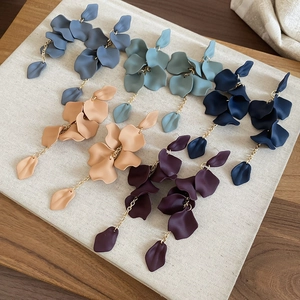 Detail of acrylic flower petal tassel earrings in various Morandi colors and gold chains