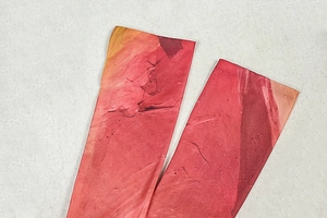 Detailed close-up of elastic arm sleeves featuring a red abstract rock texture print
