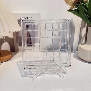 Macro shot of a 20-slot clear acrylic display box with magnets for miniature collectibles