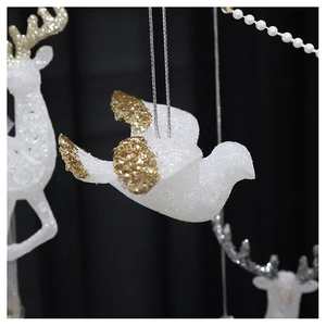 Close-up of a white glitter pigeon ornament with gold wings for Christmas tree decor