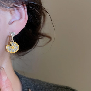 Detailed side view of a lemon slice earring with yellow enamel and sparkling crystals