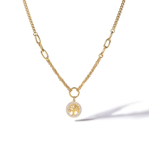Macro detail of golden Tree of Life pendant with white cubic zirconia and mixed chain links