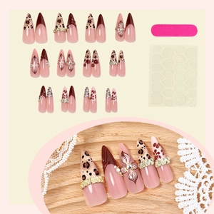 Long almond leopard print press-on nails set with floral accents and metal rings