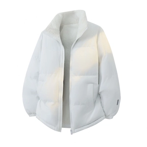 Close-up of white padded jacket showing warm fleece lining and checkerboard sleeve patch