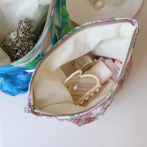 Detail of floral and abstract print pouches showing large storage capacity and fabric texture