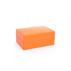 Premium orange faux leather watch display box with minimalist flip-top design and textured surface