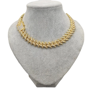 16mm gold plated thorn Cuban chain with iced out crystals on a grey velvet display