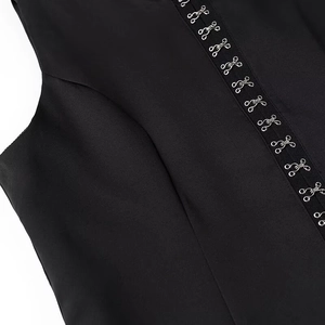 Detail of silver metal hook-and-eye closures on a black sleeveless vest top