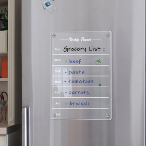Detail showing transparent acrylic weekly planner with magnetic studs on a fridge