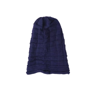 Detailed view of the navy blue chunky knit pattern and ribbed cuff on the warm beanie