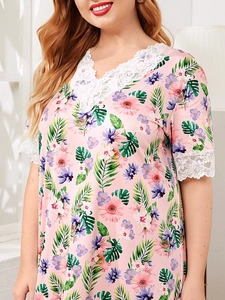 Detail of the V-neckline featuring white floral lace trim on pink floral nightgown