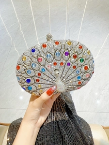 Detailed view of luxury peacock evening clutch bag with colorful rhinestones and crystals