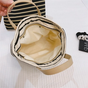 Detailed interior of striped canvas tote with durable inner zipper pocket and lining